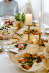 Festive table with food, wine and candles.