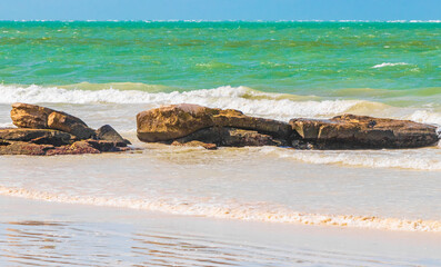 Beautiful Holbox island beach sandbank boulders turquoise water waves Mexico.