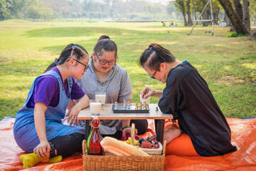 group of friends with down syndrome playng chess board together