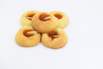 Thumbprint cookies with apricot jam and almonds, white background