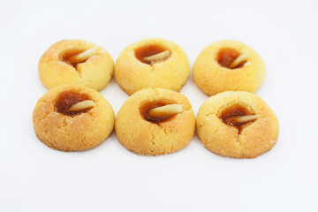 Thumbprint cookies with apricot jam and almonds, white background