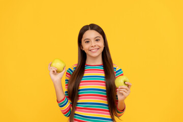 Happy girl kid hold apples yellow background, child nutrition