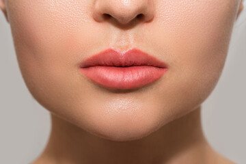 Female lips after permanent makeup lip blushing procedure - obrazy, fototapety, plakaty