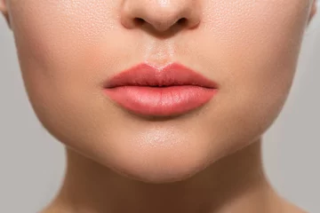 Fotobehang Female lips after permanent makeup lip blushing procedure © blackday