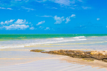 Beautiful Holbox island beach sandbank boulders turquoise water waves Mexico.
