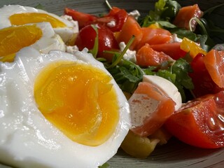 salad with salmon, egg and cherry close-up