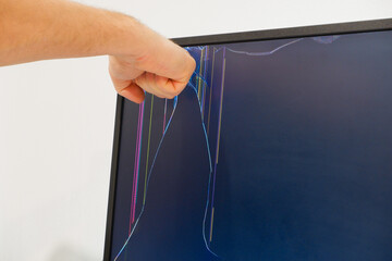 Male hand breaks the monitor screen. Broken LCD monitor. Punching the monitor. Broken LED screen