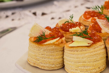 Party Brunch table setting with red caviar on white plate