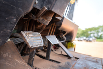 Close-up at break pedal step of a factory forklift. Industrial vehicle object part photo. Selective focus.
