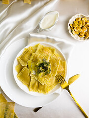 Ravioli with pumpkin and eggs. Dill noodles. Dough with dill leaves