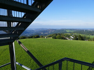 Fototapeta premium View from the Schombergturm (Schomberg tower) on the Schomberg near the village Wildewiese towards the forests and mountains of the Sauerland, North Rhine-Westphalia, Germany Blick vom Schombergturm