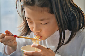 カップラーメンを食べる子供