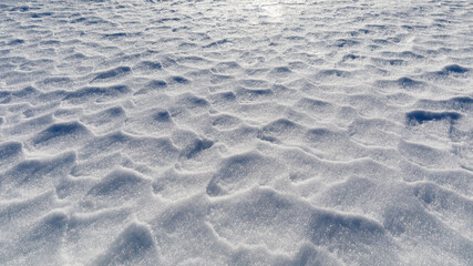Textured background of a wind-rippled snow surface. Horizontal banner