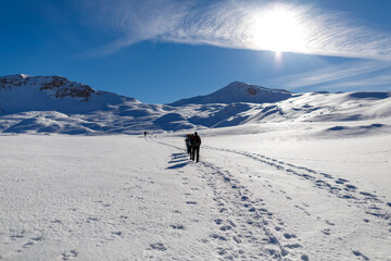 Group of hikers on the snow in the mountains.