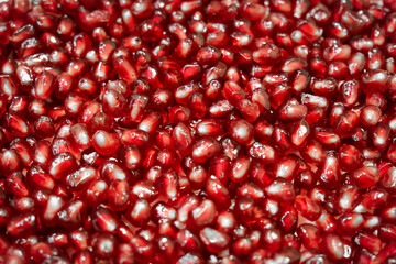 Close-up of fresh and ripe pomegranate seeds. Texture of pomegranate seebs as background.
