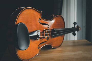 Photo of Violin on wooden table.