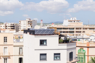 Fototapeta na wymiar Solar panels on the roofs of buildings. Views of the roofs of modern buildings. Creating clean, renewable energy on the roofs of buildings.