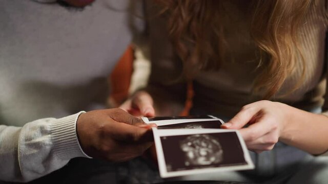 White woman and black boyfriend with ultrasound pictures