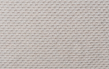 Knitted texture. Fragment of light brown fabric