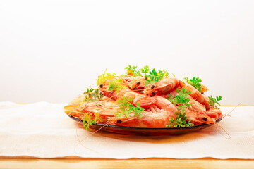 Appetizing Shrimp beautifully decorated with parsley in a plate on the table,With rustic cloth
