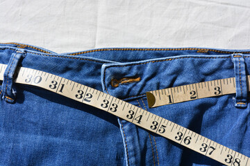measuring tape on jeans