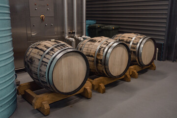 old oak wood barrels with beer in the underground cellar