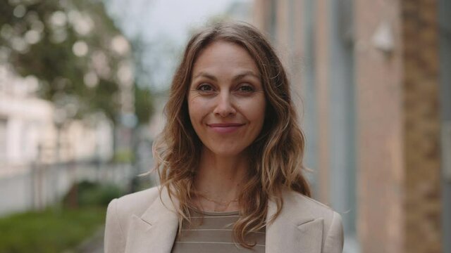 Business lady smiling and looking on camera outdoors