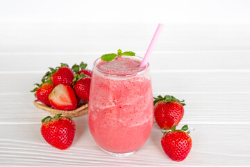 Strawberry yogurt fruit juice smoothie pink colorful fruit juice milkshake blend beverage healthy high protein the taste yummy In glass drink episode morning on white wood background.