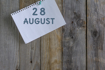 Day of month.A white sheet of checkered paper from a notebook with a date is pinned with a...