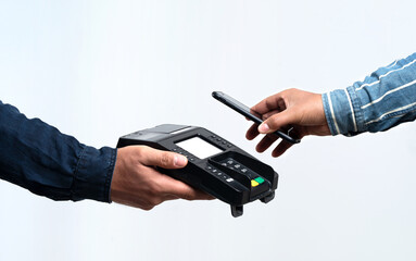 Hands holding pos device and smartphone on isolated white background. Contactless and easy payment concept.