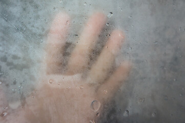 Fototapeta premium Hand seen through a misty glass