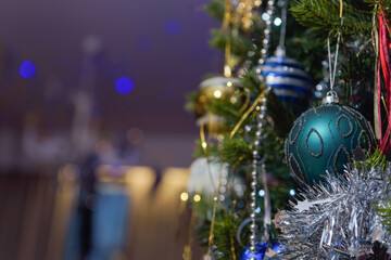 Fragment of a decorated Christmas tree. Dark blue background. Selected focus. Copy space