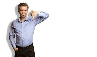 Frowning man showing negative feedback disapproval dislike sign.