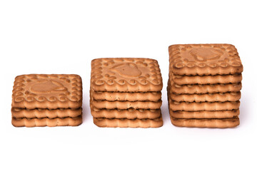 Shortbread cookies are arranged in three stacks of different sizes and photographed against a white background. Confectionery and sweets