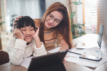 Loving mother supporting tired daughter study together at home. mom helping comfort school girl having difficulty with education learning at home.