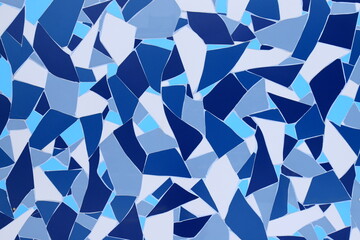 Broken vintage tiles pattern on the wall, floor. Background, texture of blue white tiles. Beautiful abstract decorative material for interior of the house, building, design.