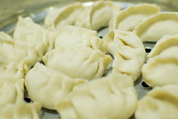 Momo , type of South Asian dumpling; native to Tibet, Nepal, Bhutan and Sikkim. It is similar to Chinese baozi and jiaozi, Mongolian buuz, Japanese gyoza and Korean mandu. Stock photograph.