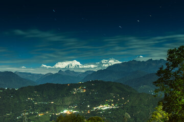 Beautiful view of moonlit Kanchenjungha Mountain Range of great Himalayas, shot in a full moon night. Rinchenpong, Sikkim, India