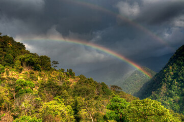 Beautiful rainbow on cloudy sky over Himalayan mountains at Sikkim, West Bengal, India.