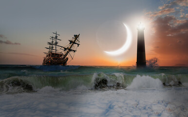 An old sailing ship in the mist sails towards the rocks with amazing lighthouse, crescent in the...