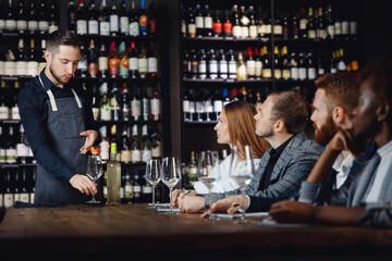 Tasting of white wine in restaurant under guidance of sommelier