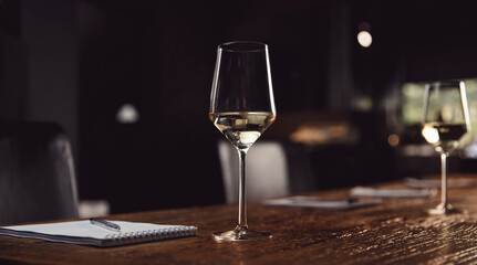 Banner Tasting white wine, row glasses with alcohol and notepad on table, top view