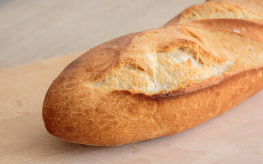 cloesup of a french baguette bread on a wooden board