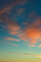 scattered cirrus clouds beautifully illuminated by the setting sun