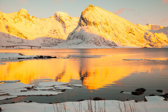 Sunset in fjord among the snow in Norway With big mountains in the background © Javier