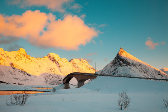 bridge linking islands in lofoten, norway between fjords and snow