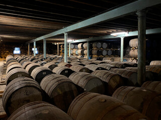 Casks of aging scotch whisky at a distillery in central Scotland - obrazy, fototapety, plakaty