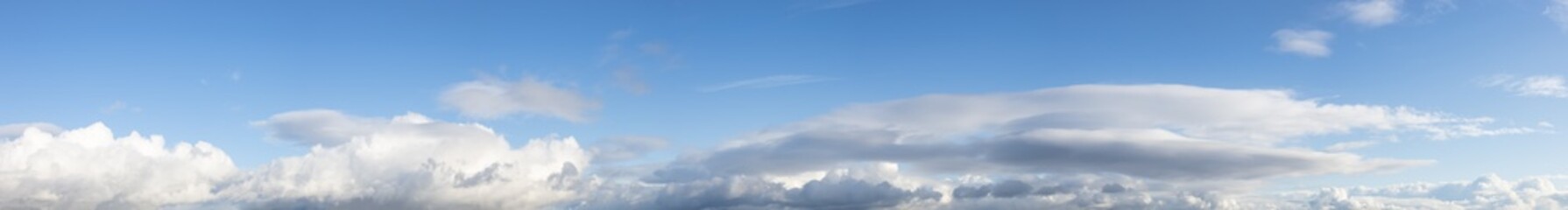 Panoramic View of Cloudscape during a cloudy blue sky sunny day. Taken on the West Coast of British Columbia, Canada.