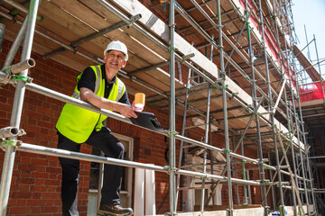 Construction Worker Foreman Builder on Building Site Clipboard and Mug