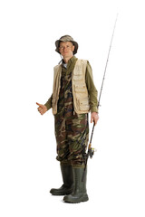 Portrait of young man, professional fisherman with fishing rod, spinning and equipment going to river isolated over white studio background